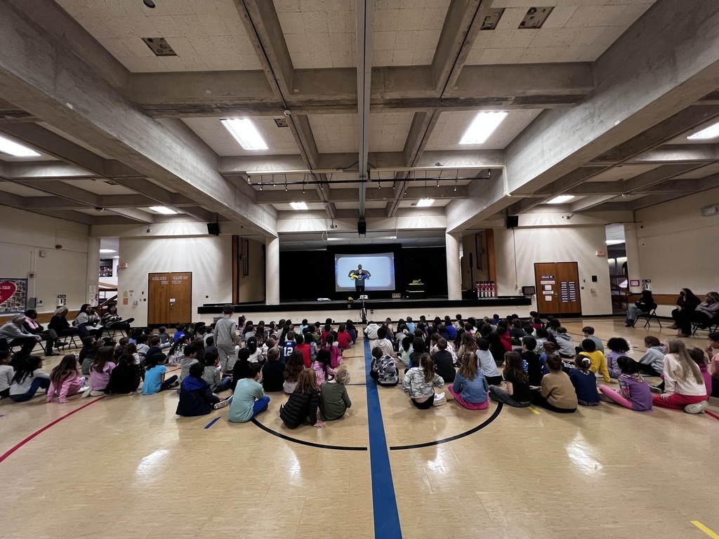 students in auditorium sitting down for presentation about the environment 2