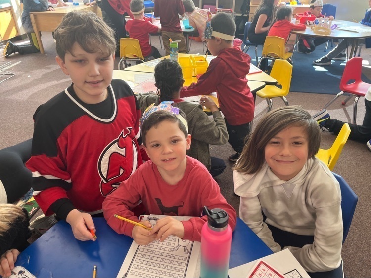 Photo of three students sitting on the table crafting Kindergarten celebrated the 100th day of school with their 5th grade buddies. #SBhasHEART